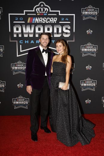 NASCAR Cup Series driver Denny Hamlin (L) and Jordan Fish (R) pose for a photo on the red carpet.