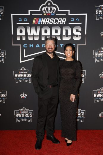 NASCAR Cup Series driver, Martin Truex Jr. (L) and Emily Collins (R) pose for a photo on the red carpet.