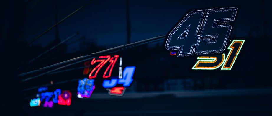 Lights hang about over pit road at Kansas Speedway.