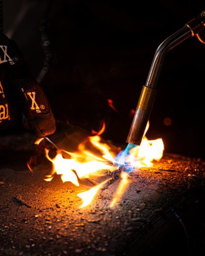 Flames shoot across a tire.