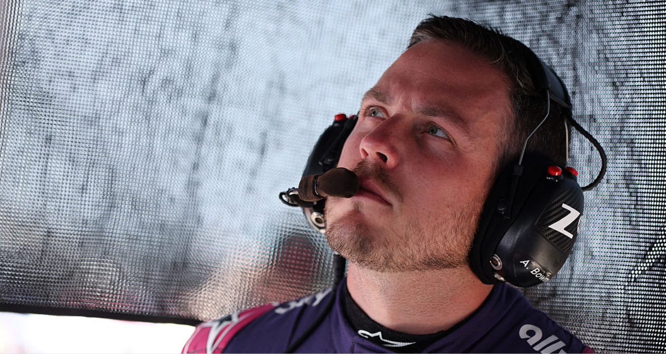 Alex Bowman looks on.