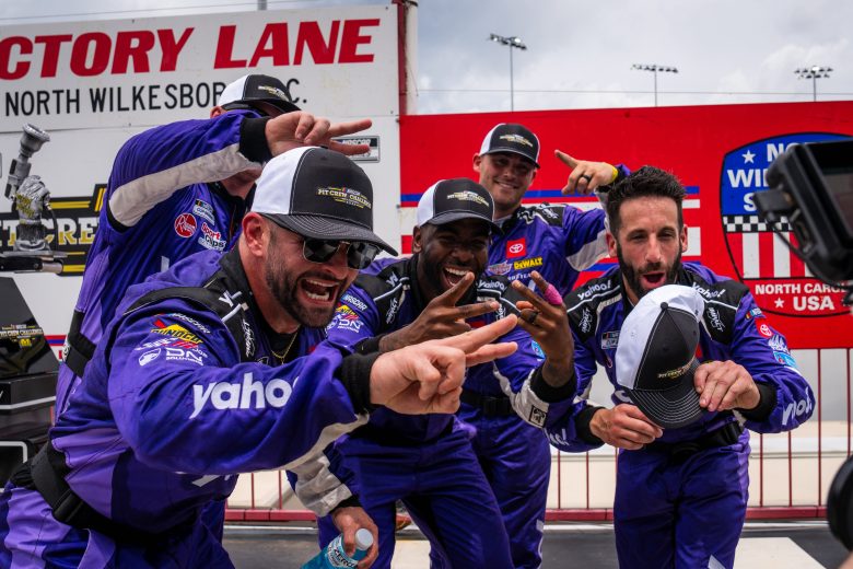 The No. 20 pit crew celebrates and poses for a photo following their All-Star Pit Crew Challenge victory at North Wilkesboro Speedway.