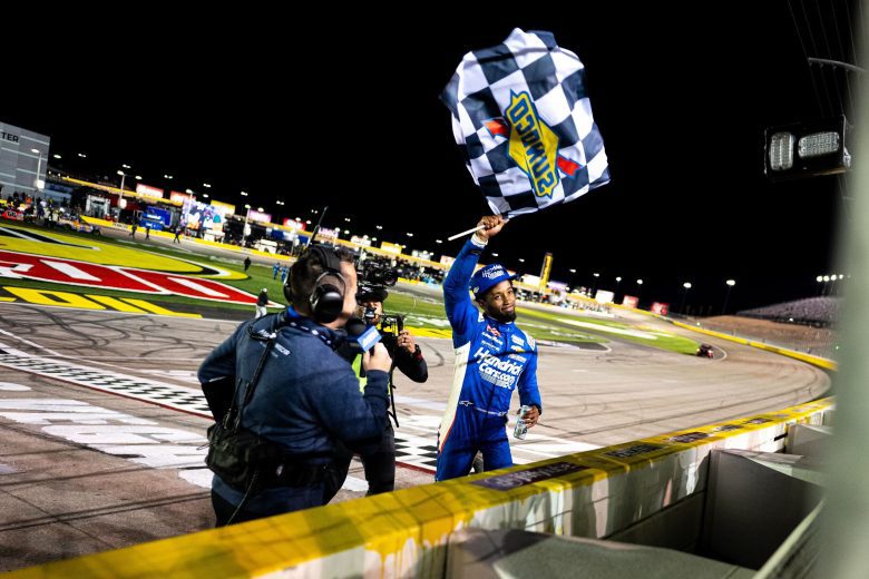 Rajah Caruth waves the checkered flag following his NASCAR Craftsman Truck Series win at Las Vegas Motor Speedway.