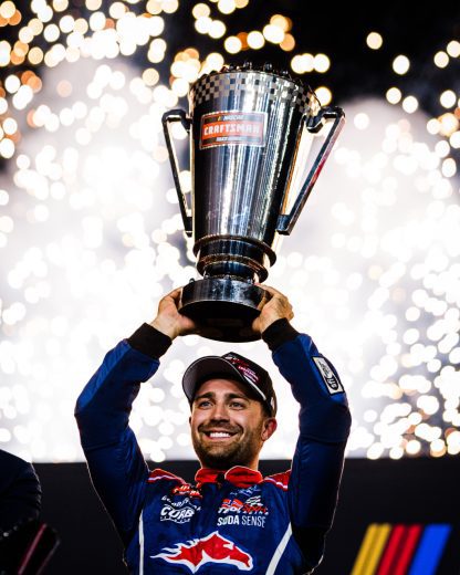 Ty Majeski hoists the NASCAR Craftsman Truck Series Championship trophy at Phoenix Raceway.