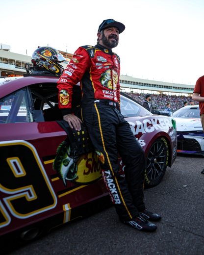 Martin Truex Jr. leans on his No. 19 Joe Gibbs Racing Toyota.