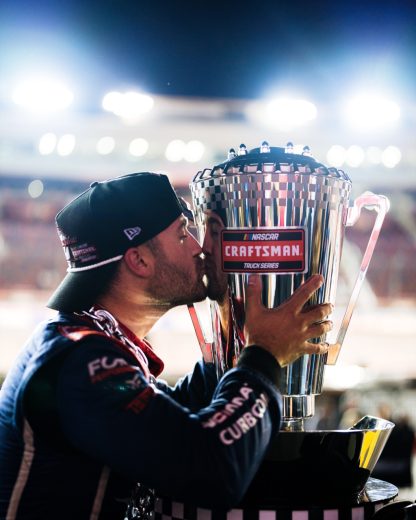 Ty Majeski kisses the NASCAR Craftsman Truck Series Championship trophy.