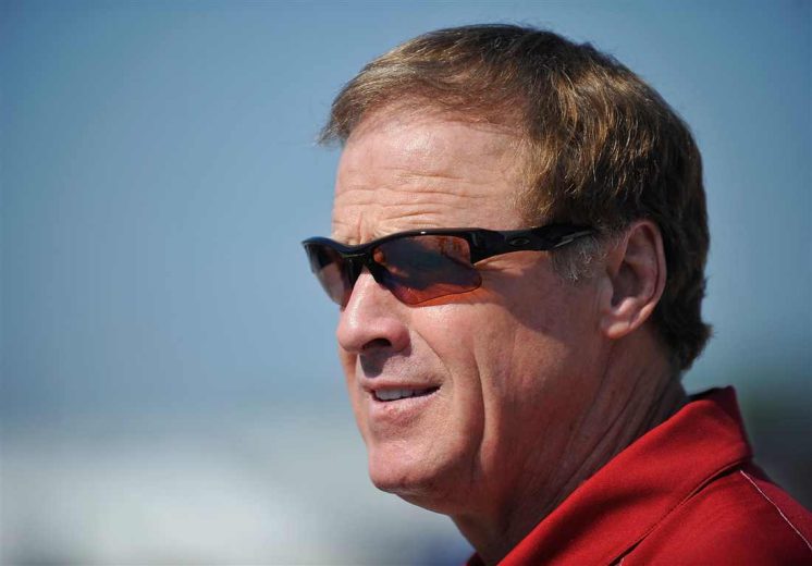 Rusty Wallace looks on.