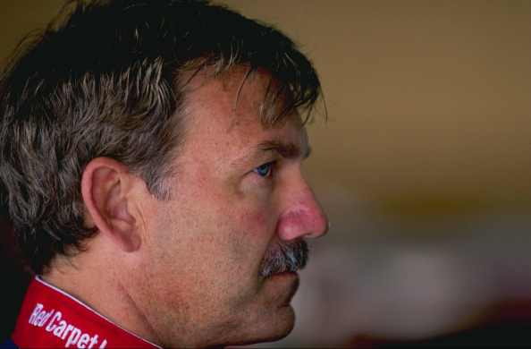 Dale Jarrett looks on.