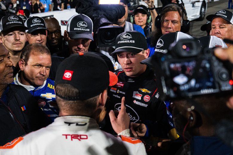 Taylor Gray (foreground) confronts Christian Eckes as a crowd surrounds the pair at Martinsville Speedway.