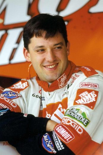 Tony Stewart looks on.