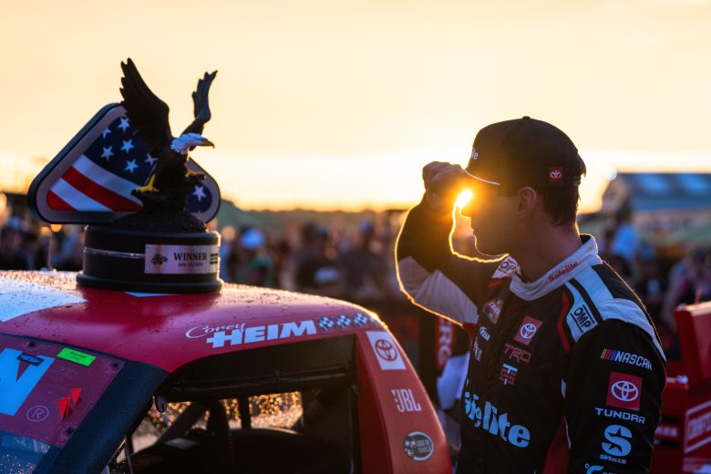 Corey Heim tips his hat as the sun sets underneath his brim at Pocono Raceway.