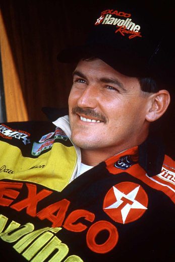 Davey Allison looks on.