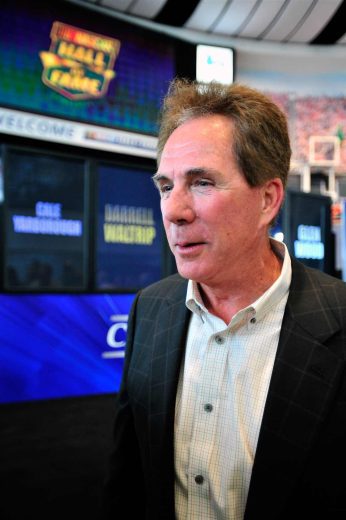 Darrell Waltrip looks on.