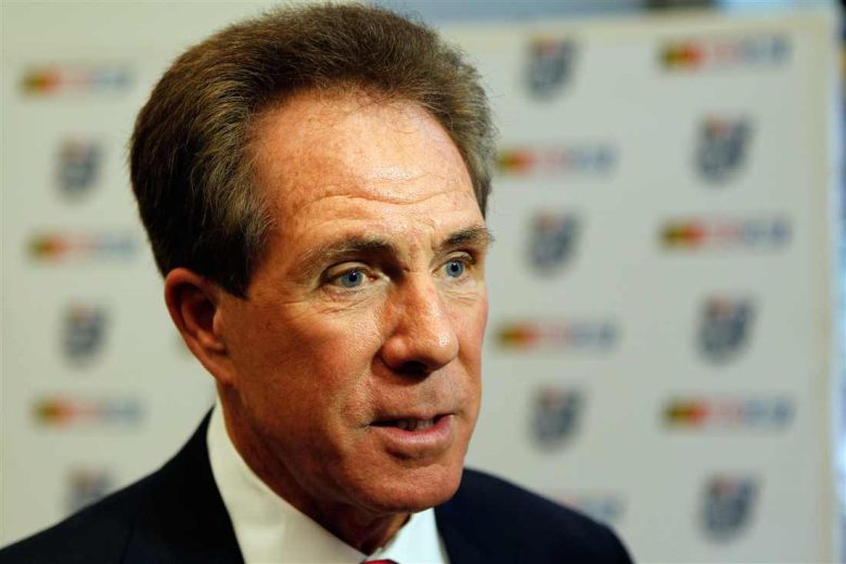 Darrell Waltrip looks on.