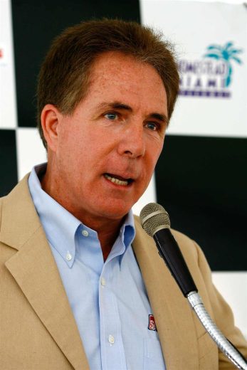 Darrell Waltrip looks on.
