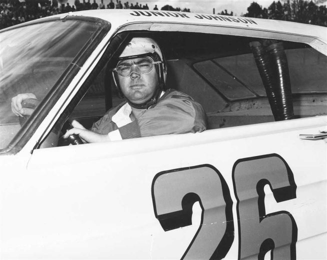 Junior Johnson sits in his car.