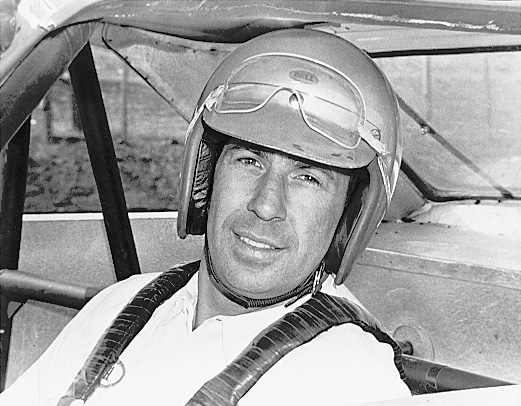 Ned Jarrett sits in his car.