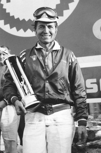 Tim Flock holds a trophy.