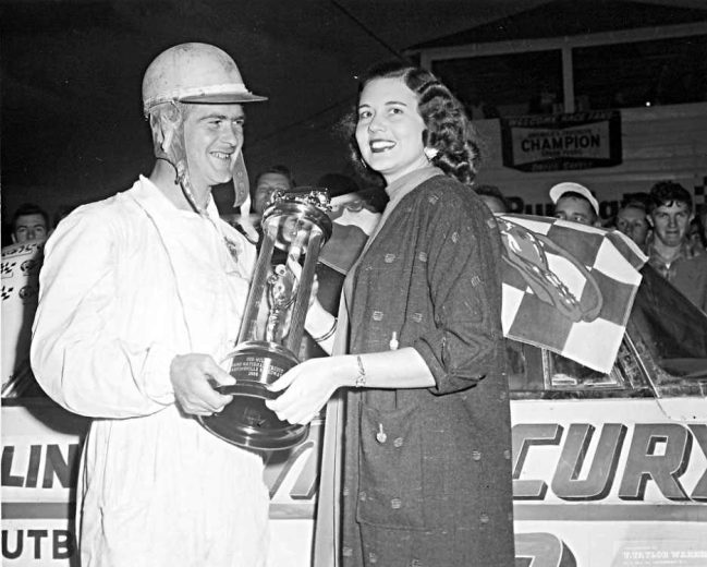 Speedy Thompson holds a trophy.