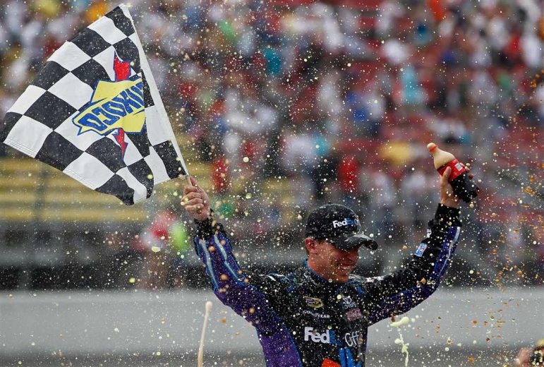 Denny Hamlin celebrates in Victory Lane at Michigan.