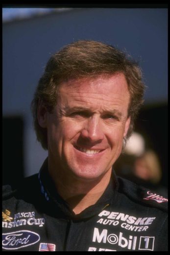 Rusty Wallace looks on.