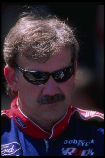 Dale Jarrett looks on.