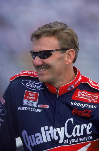 Dale Jarrett looks on.