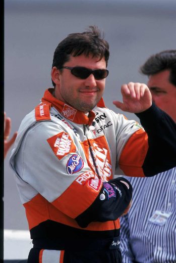 Tony Stewart looks on.