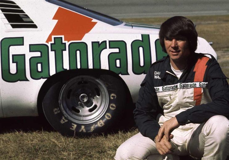 Darrell Waltrip looks on.