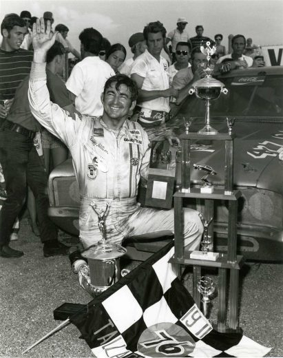 Bobby Allison poses with a trophy.