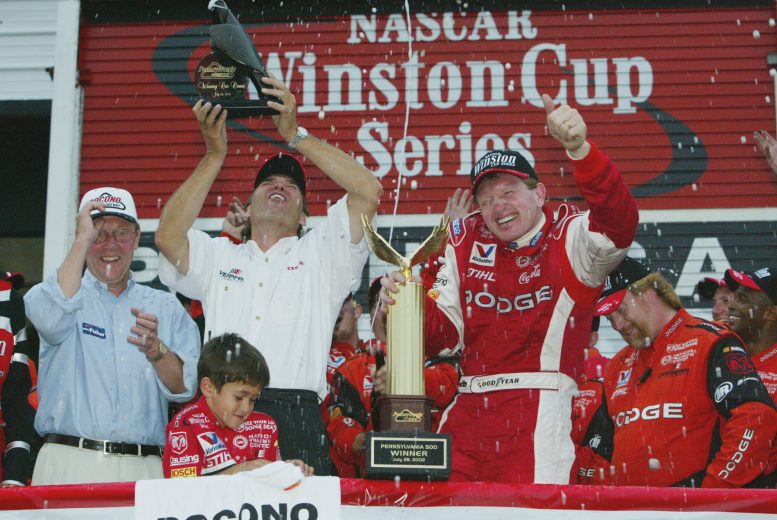 Bill Elliott holds up trophy in Pocono Victory Lane.