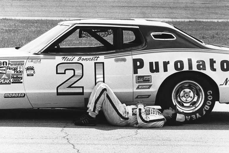 Neil Bonnett takes a break next to his Wood Brothers Purolator Mercury.