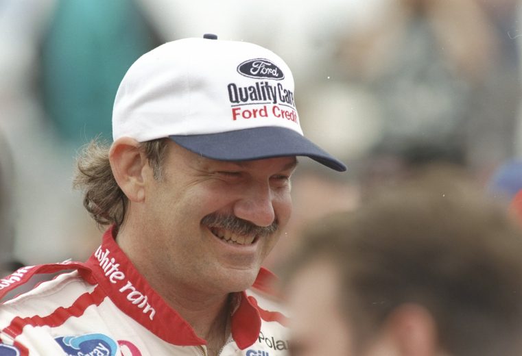 Dale Jarrett looks on and smiles.