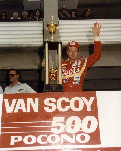 Bill Elliott holds trophy in Victory Lane.