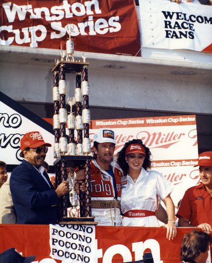 Tim Richmond holds trophy in Victory Lane.