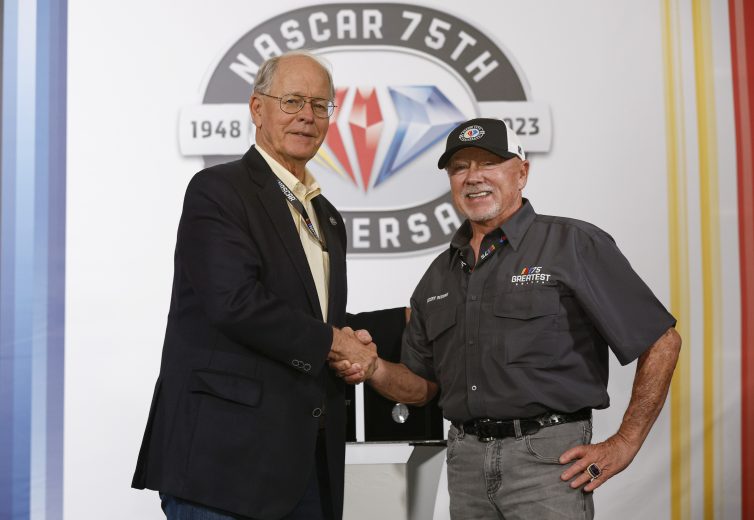Geoff Bodine stands and shake hands after being named one of 75 greatest drivers.