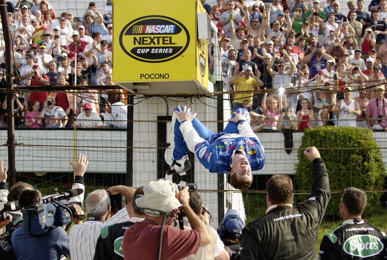 Carl Edwards climbs the fence at Pocono.