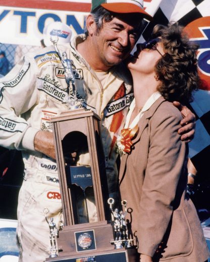 Bobby Allison smiles with trophy in Victory Lane.