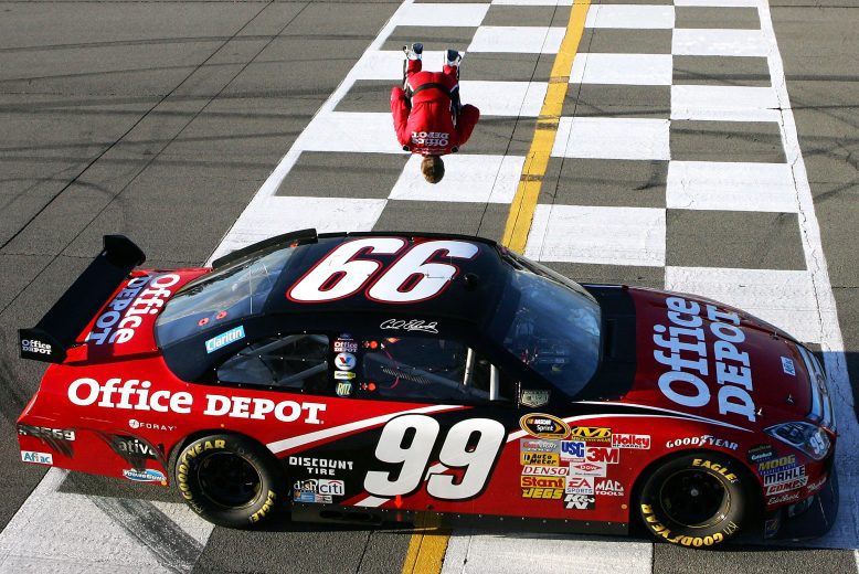 Carl Edwards does a backflip off the No. 99 car at the finish line.