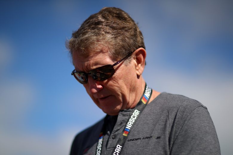 Bill Elliott looks on in sunglasses.