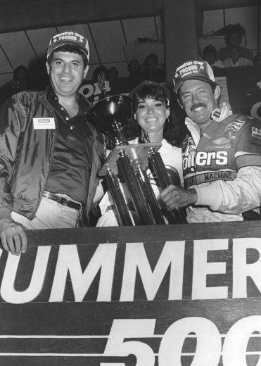 Tim Richmond holds trophy in Victory Lane.