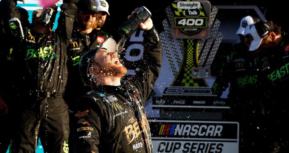 Tyler Reddick soaks in some of his sponsor's beverage in Victory Lane at Homestead-Miami Speedway