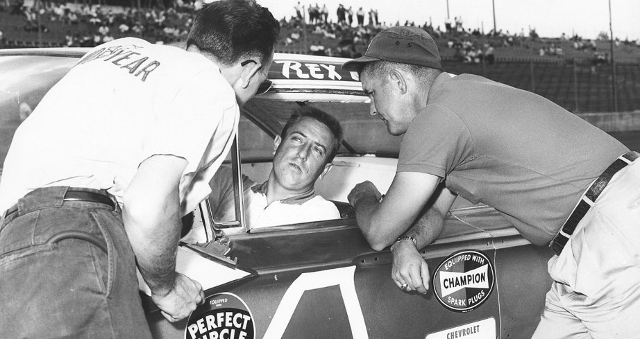 Rex White talks to crew members as he sits in No. 4 driver deat.