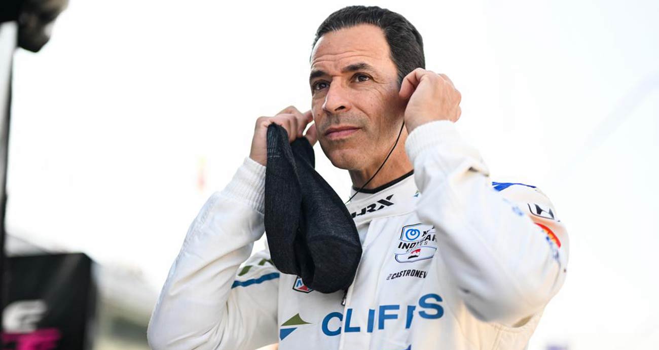 Helio Castroneves places earplugs while on the grid in preparation for the 2024 Indianapolis 500