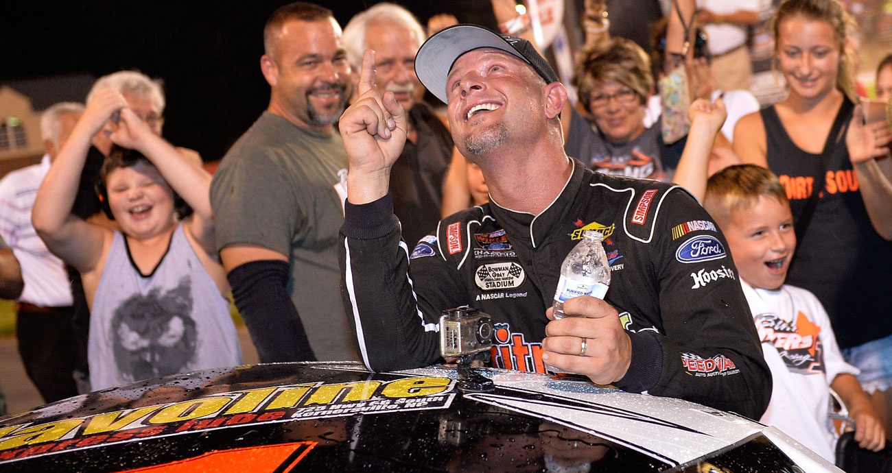 Burt Myers smiles and points skyward