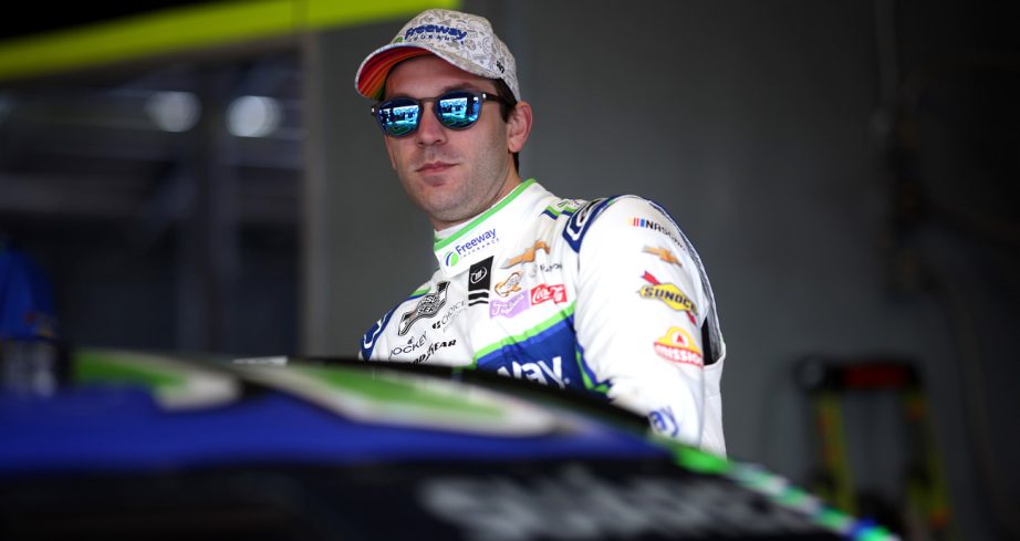 Daniel Suárez climbs into his NASCAR Cup Series car.