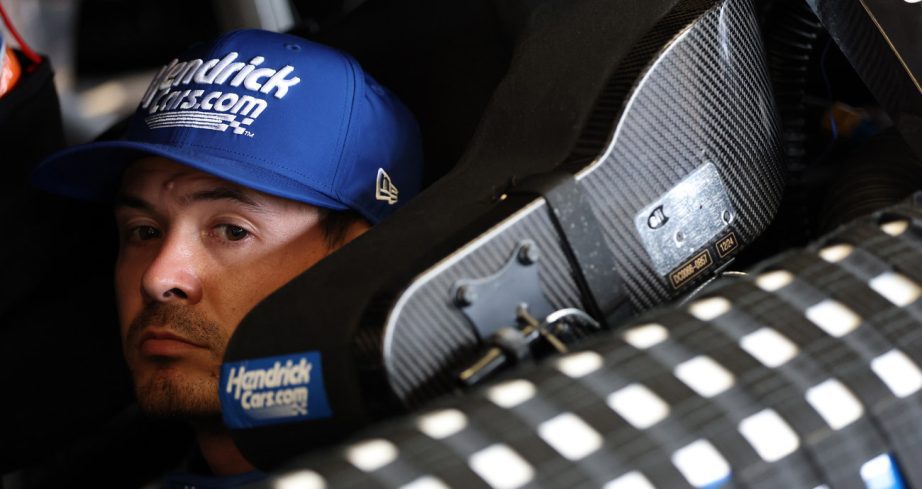 Kyle Larson sits in his NASCAR Cup Series car.