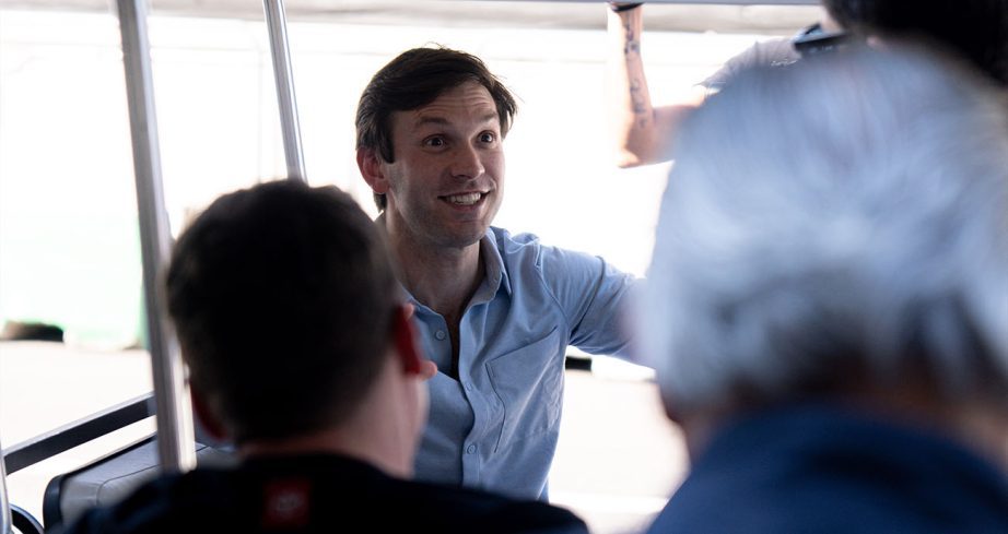 Daniel Suárez looks on from the driver seat of golf cart.
