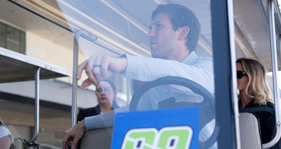 Daniel Suárez looks on from the driver seat of golf cart.