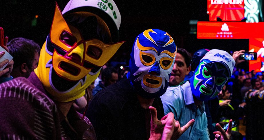 Ryan Blaney, Christopher Bell and Daniel Suárez wear luchador mask and sit ringside.